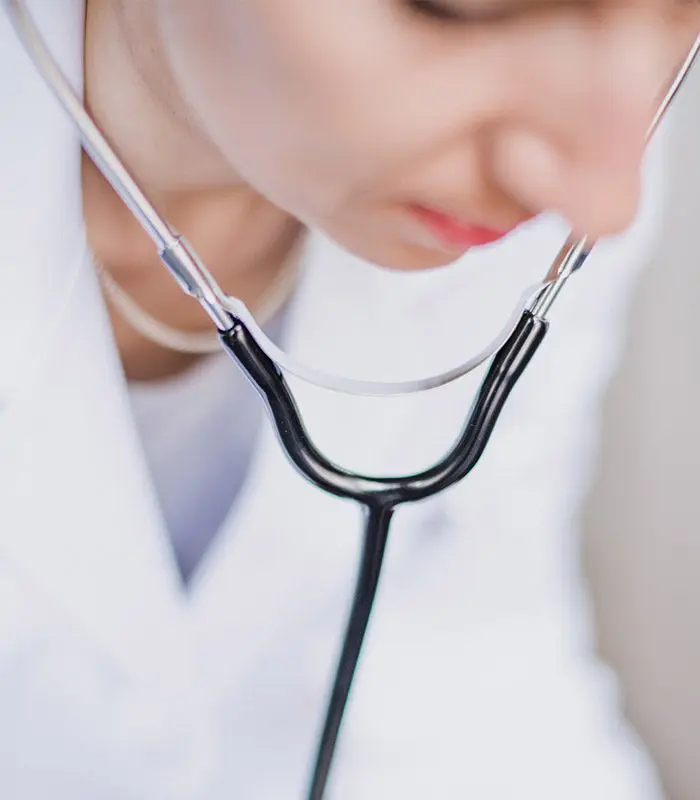 A woman with a stethoscope around her neck.