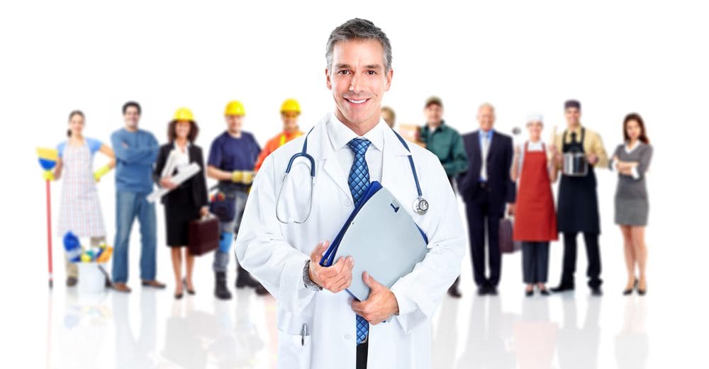 A doctor holding a clipboard in front of a group of people.