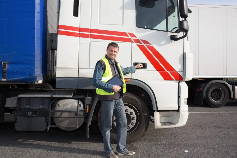 A man standing in front of a truck.